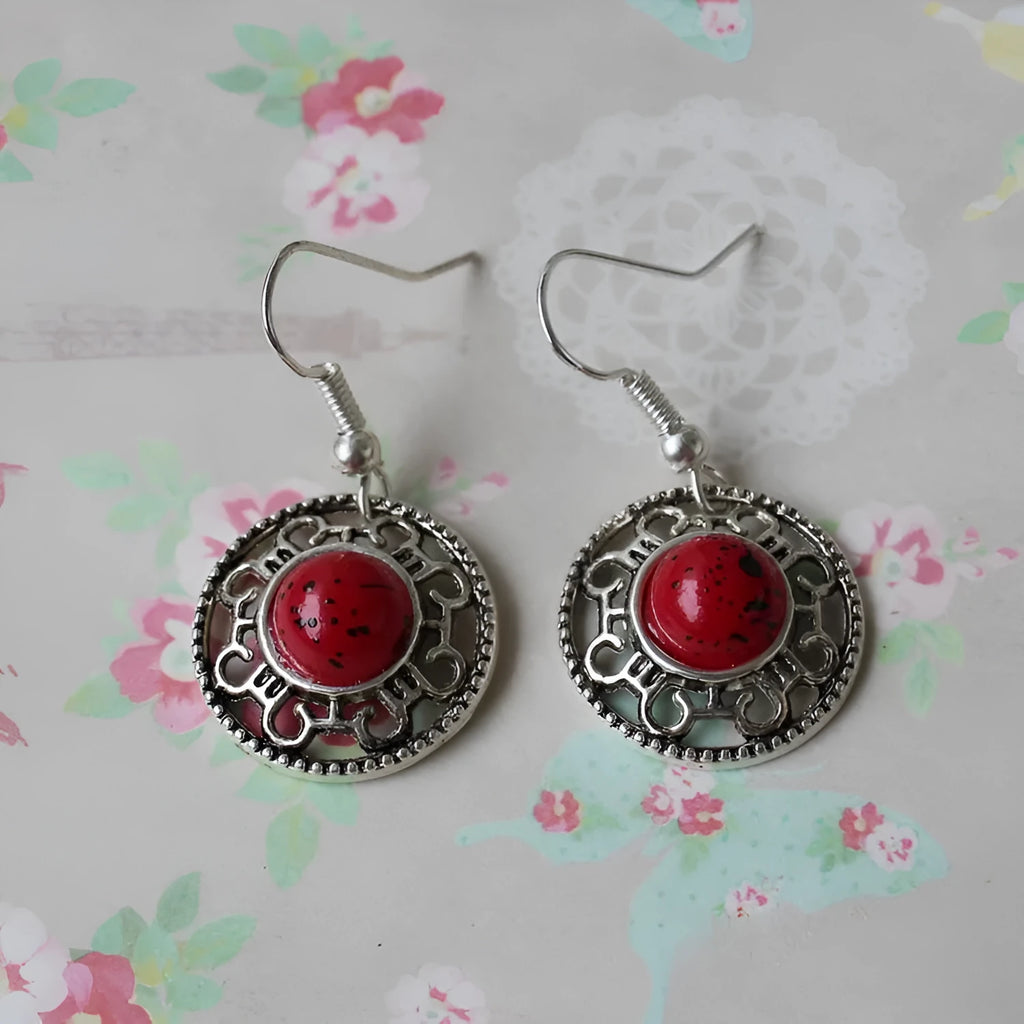 Handmade Miao silver geometric flower disk earrings with turquoise and auspicious cloud patterns in red, blue, black.