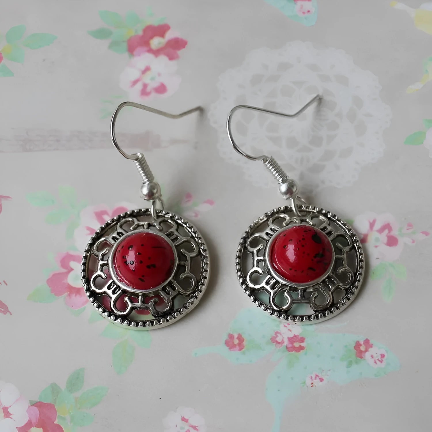 Handmade Miao silver geometric flower disk earrings with turquoise and auspicious cloud patterns in red, blue, black.