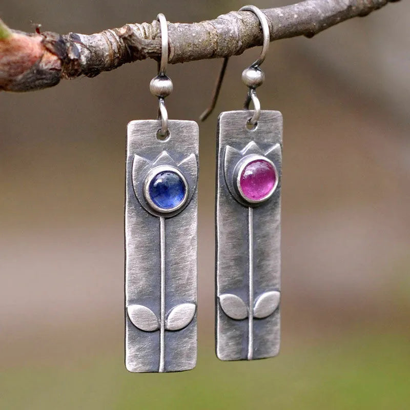 Antique finish geometric earrings with oval ellipse design and red sapphire accents