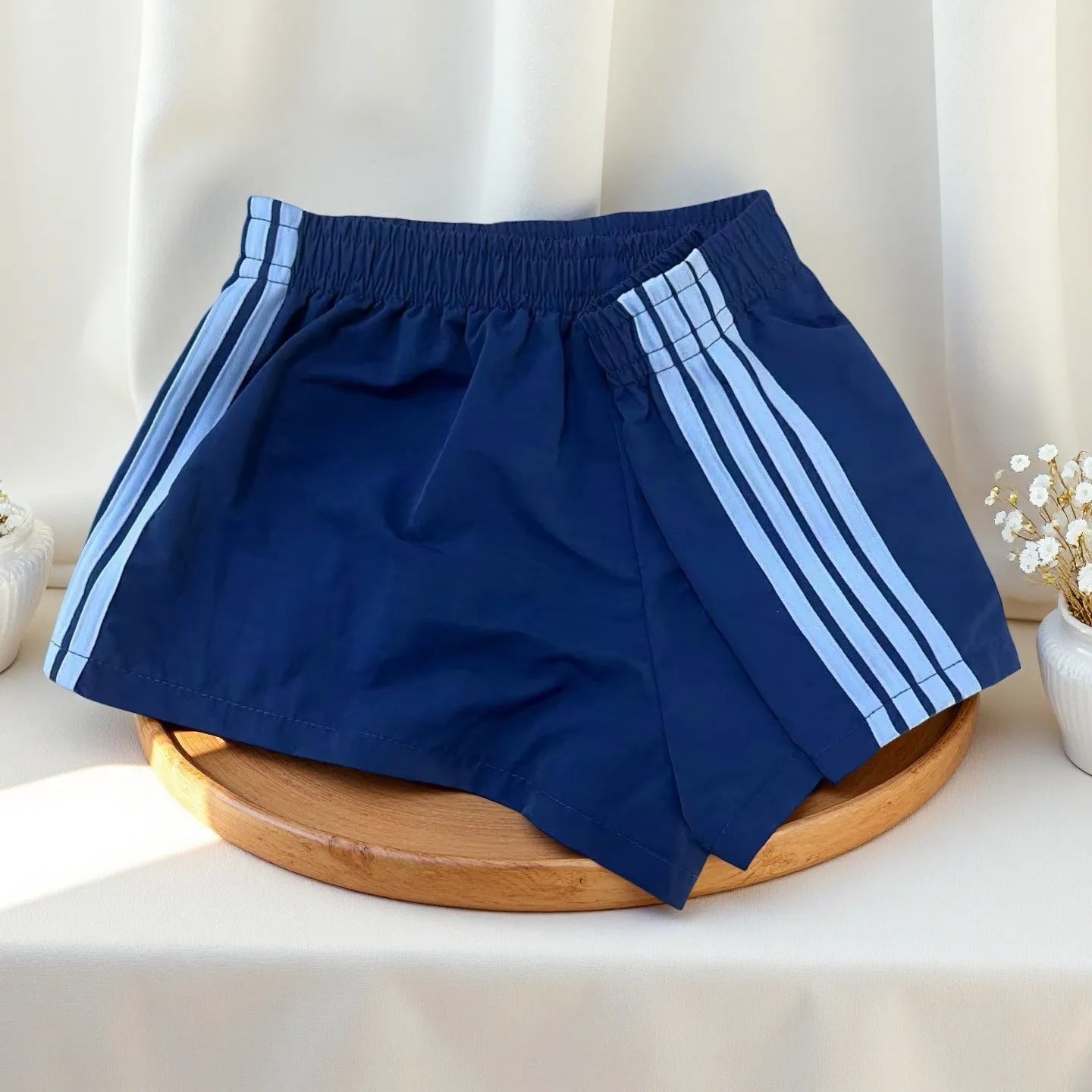 Men's navy blue high waist nylon sports shorts with micro elasticity on a white background