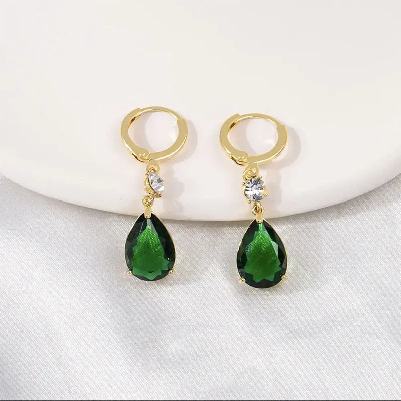 A pair of geometric teardrop-shaped earrings in emerald green colour.