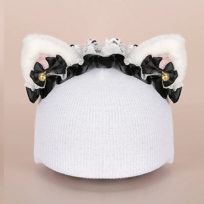 Soft plush fabric cartoon character decoration fitting on the peak of a black ski helmet.