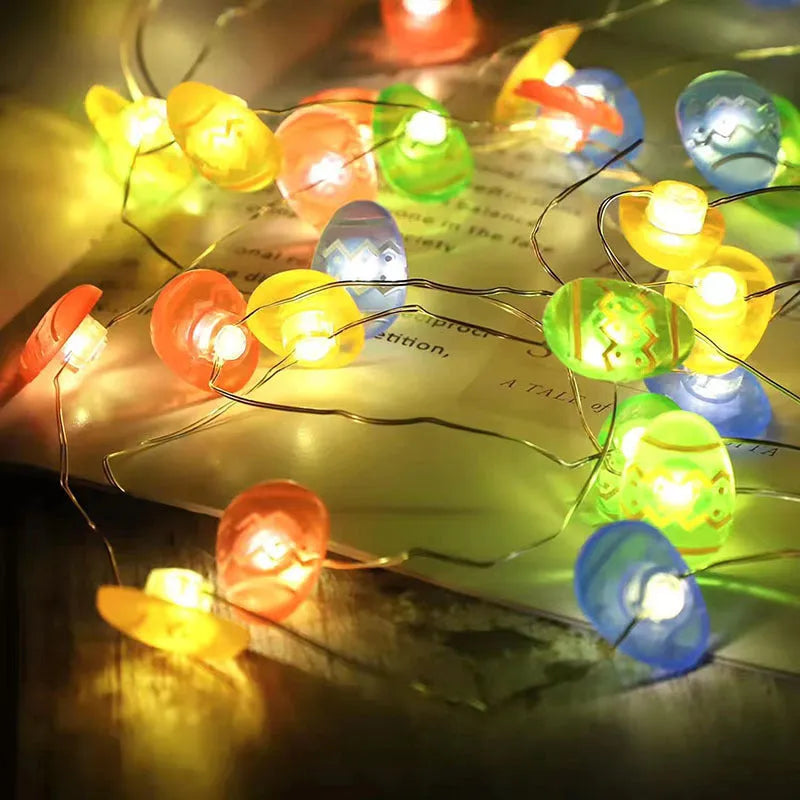 Easter carrot and rabbit shaped battery-operated LED decorative string lights on a dark background.