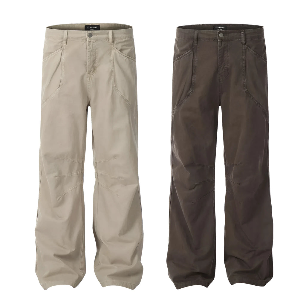 Men's brown loose-fit high-waisted straight-leg cotton trousers on a hanger.