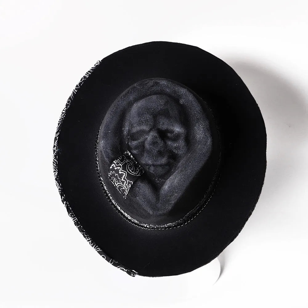 Handmade conical skull hat in wool felt and denim, shown from the side, highlighting its structured crown shape.