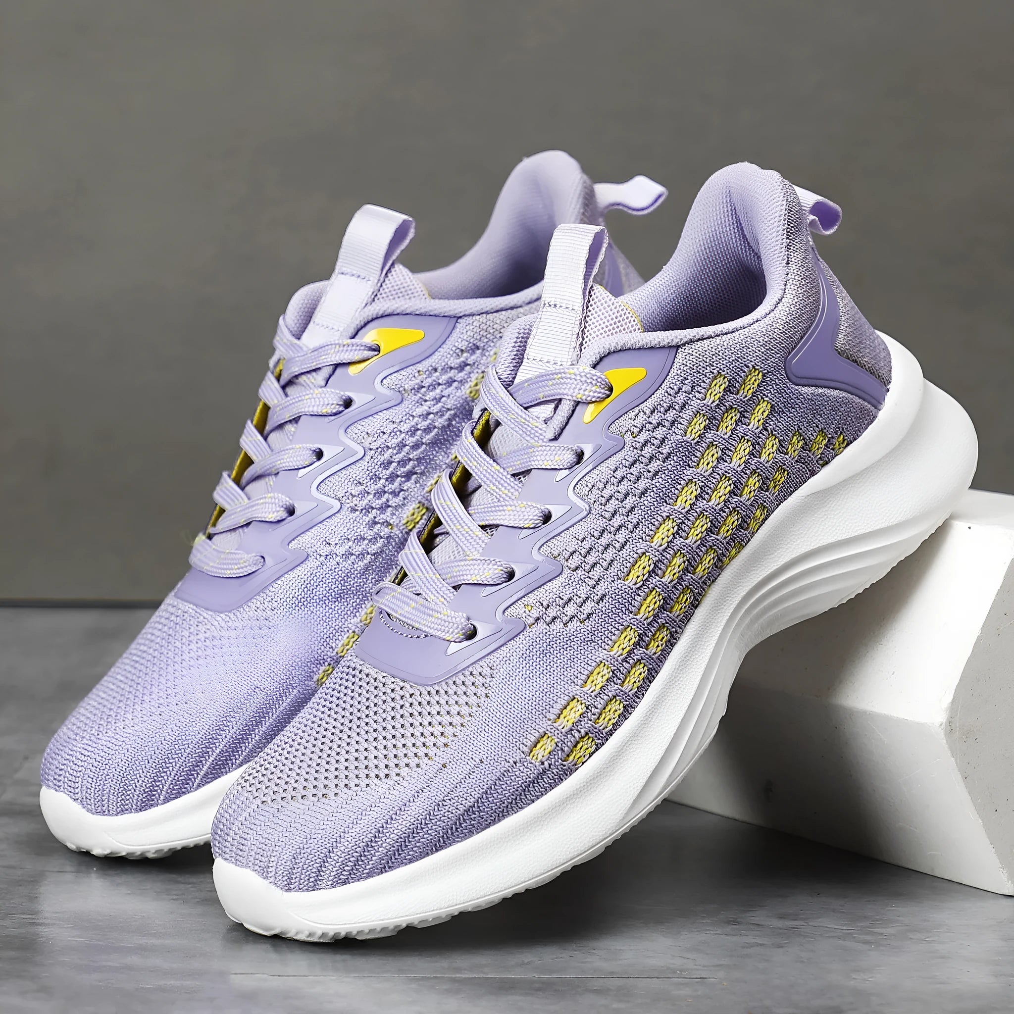 Women's Lavender Purple Flyknit running shoes with mesh detailing and a striped pattern on a white background.