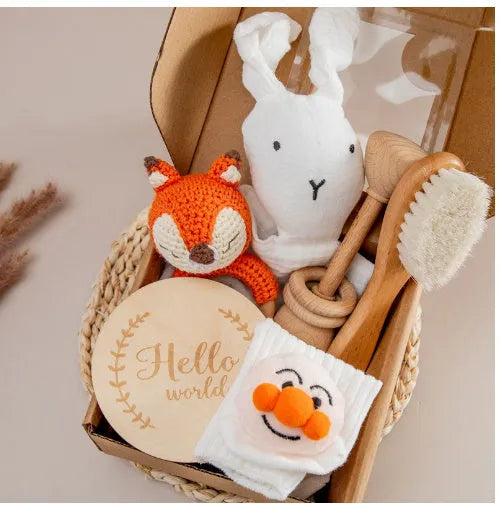 Baby teething gift set with bamboo gauze blanket, wooden chewing ring, woven bell, and developmental toys