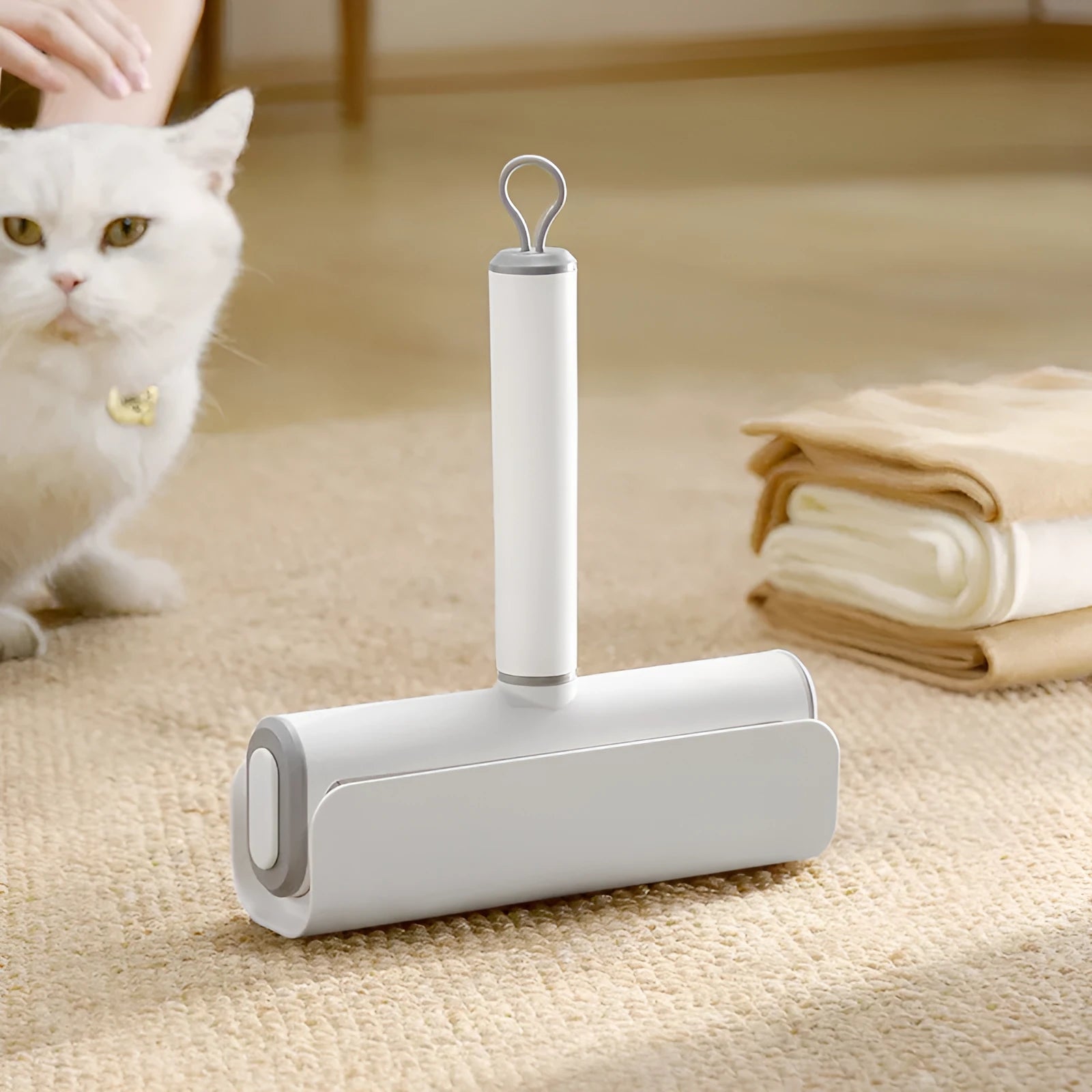 Lint remover roller pet tool with handle and four replacement paper sticks for removing cat hair.