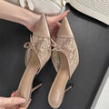 Women's light brown lace bowknot pointed toe high heels with mesh upper on a neutral background.
