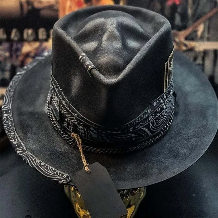 Handmade conical skull hat in wool felt and denim, shown from the side, highlighting its structured crown shape.