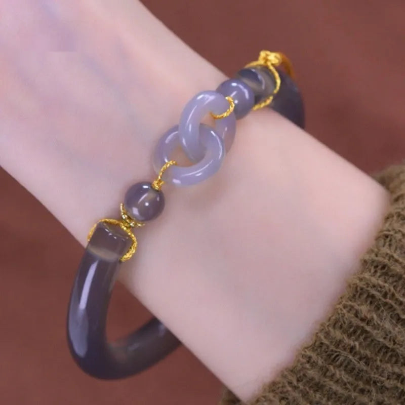 Grey retro-style half bracelet made from smoke purple agate with a visible metal ring buckle closure.