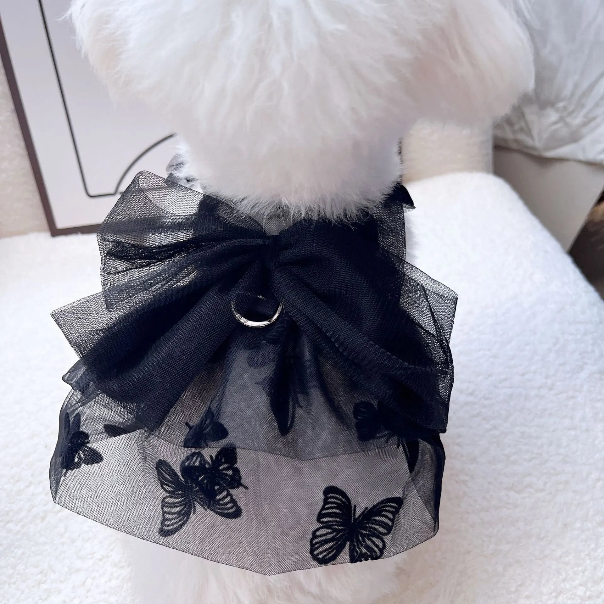 Black layered tulle princess skirt on a small dog, showing elastic waistband and tiered design.