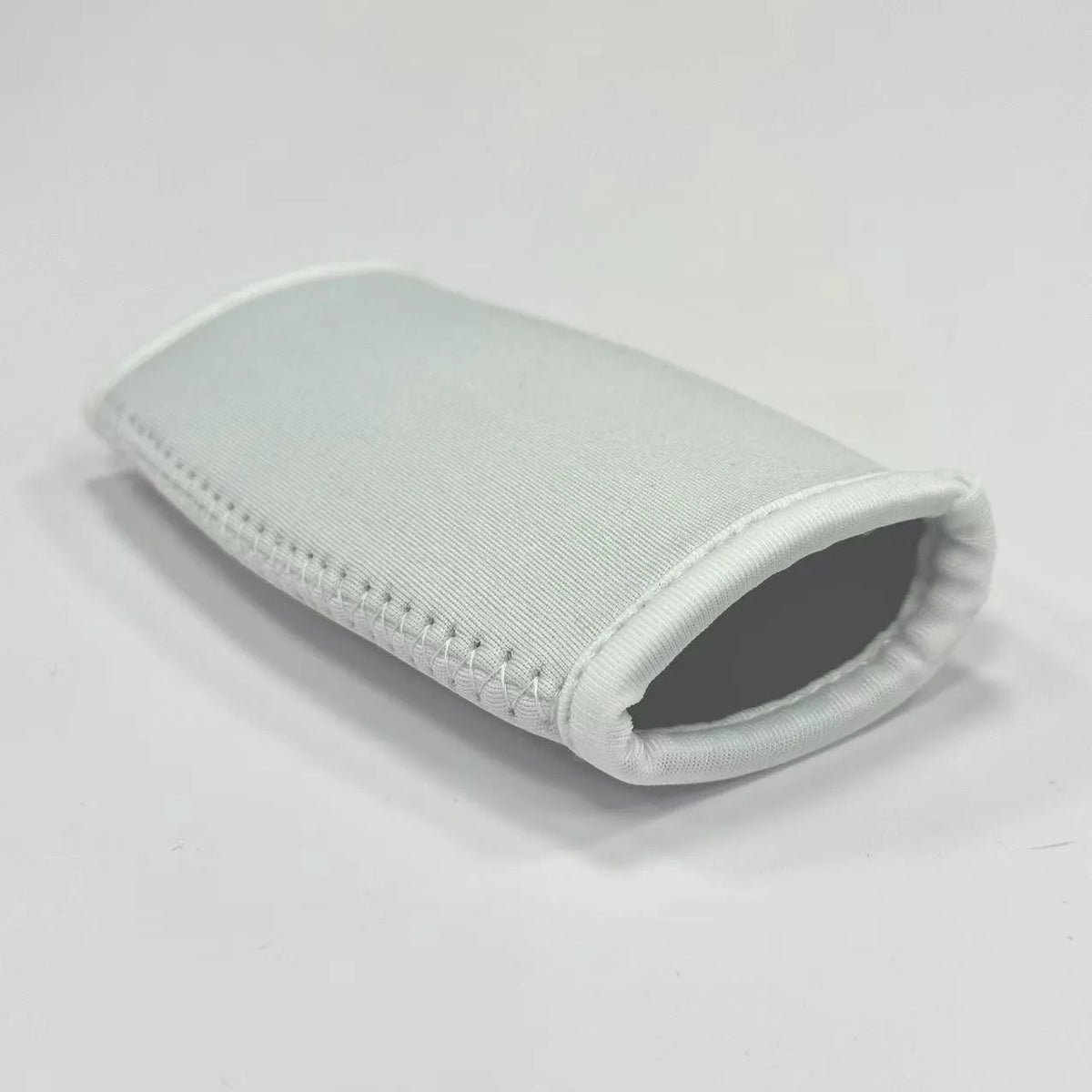 Rugby chin pad in polyester fibre, 12 x 7.5 cm, shown as an anti-collision helmet pad in black, white, blue, or grey.
