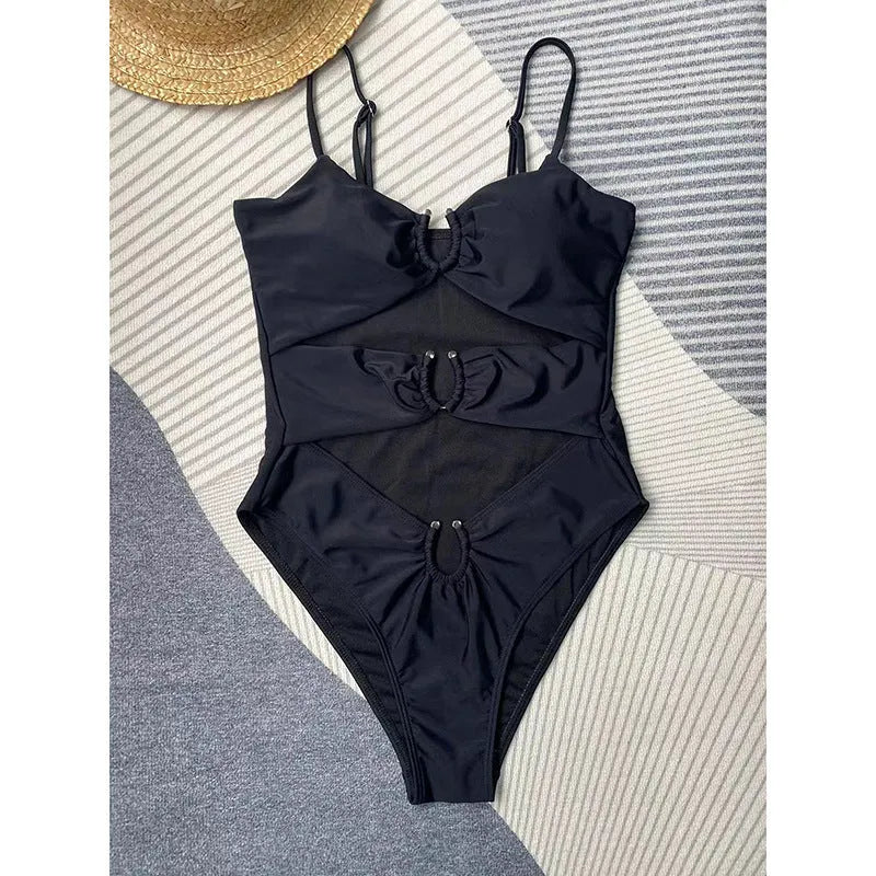 Black solid colour women's one-piece swimsuit on a hanger.