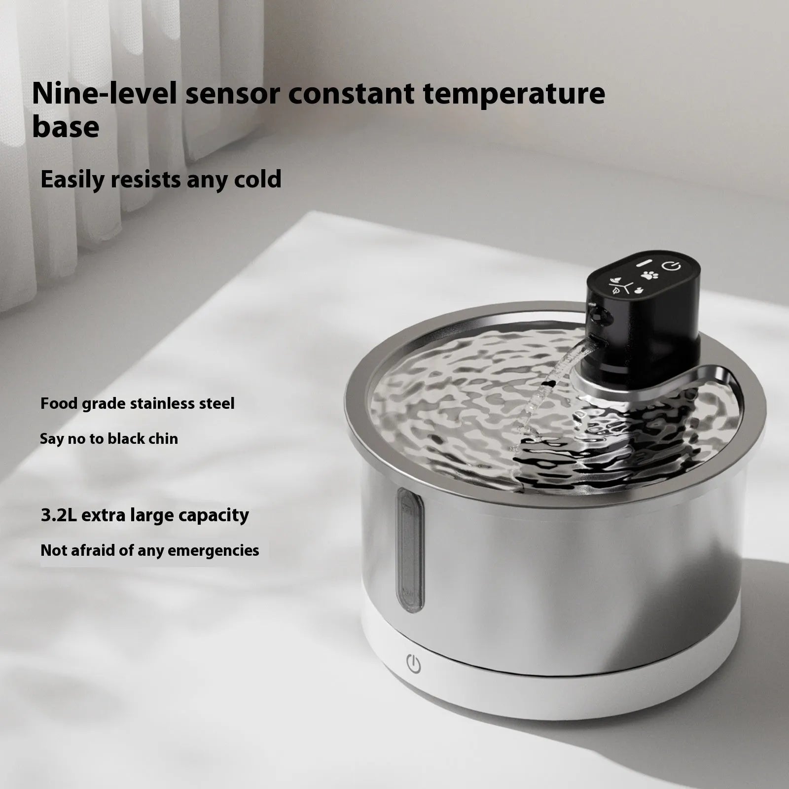 Stainless steel cat water fountain with heating base on a table.