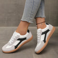 Women's low top casual sneaker in retro style with round toe and lace-up front.
