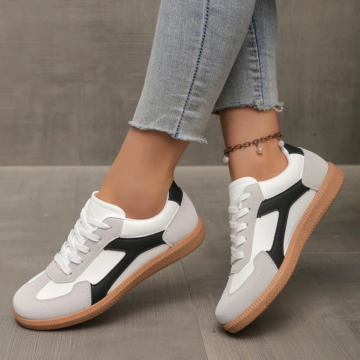 Women's low top casual sneaker in retro style with round toe and lace-up front.