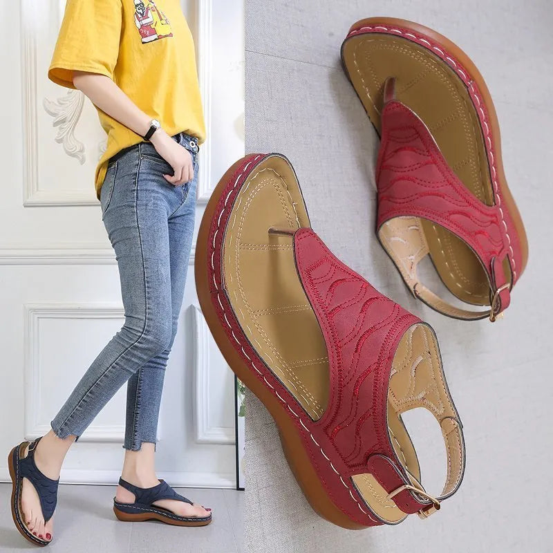 Women's casual wedge heel flip flop sandal in black with adjustable buckle strap.