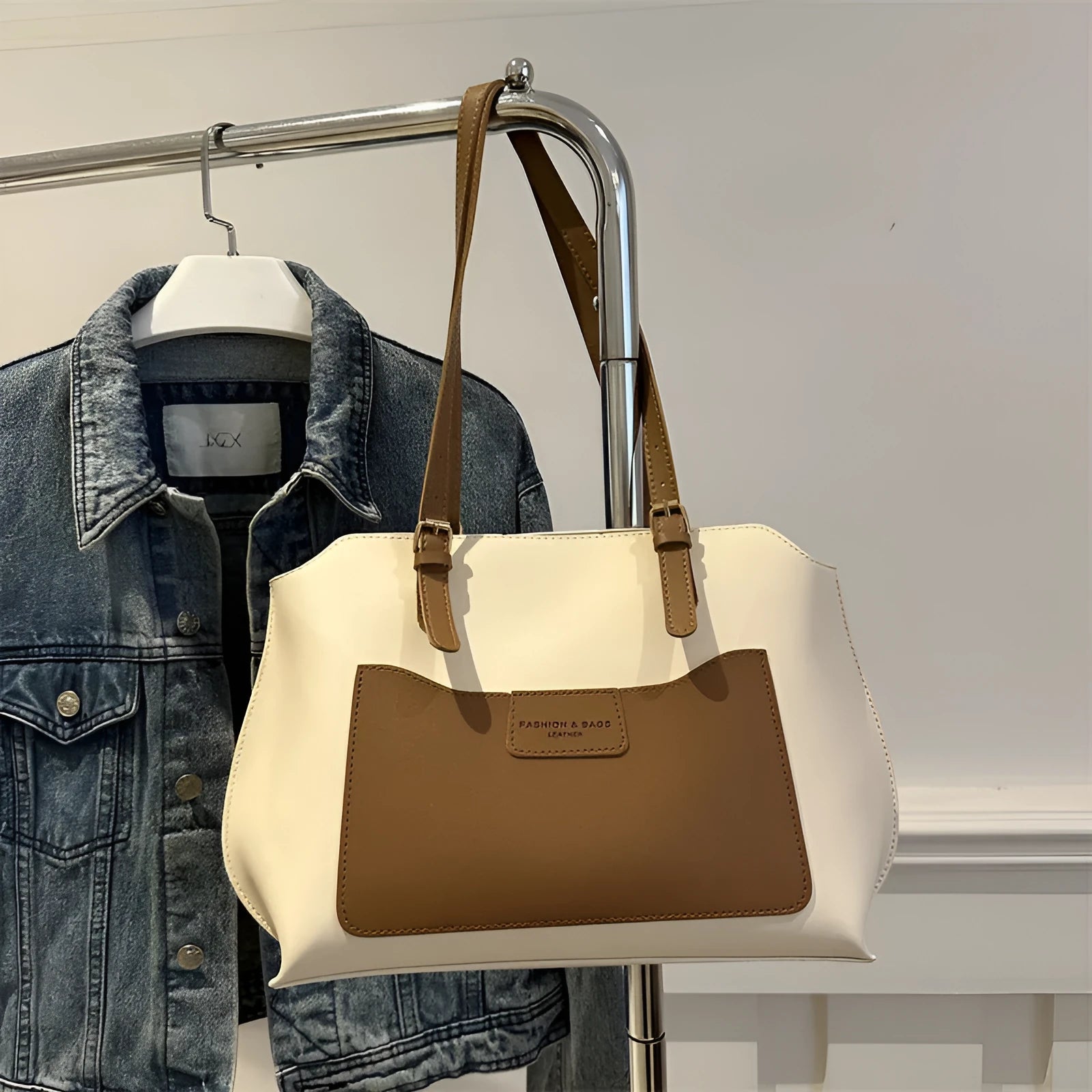 Women's square PU tote bag in black with double straps, showing external sandwich pocket and sewing line detail.