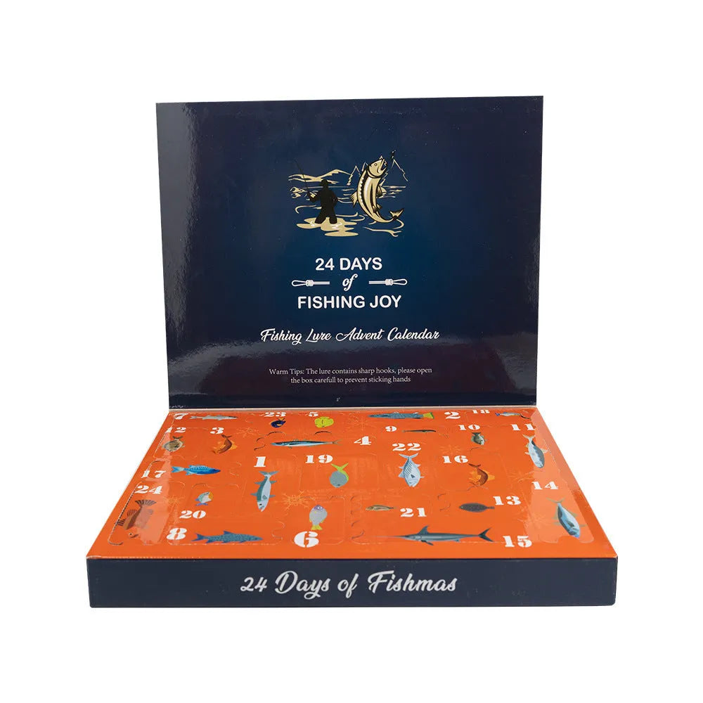 Christmas-themed metal blind box open to show 24 assorted bog-style fishing flies on a green background.