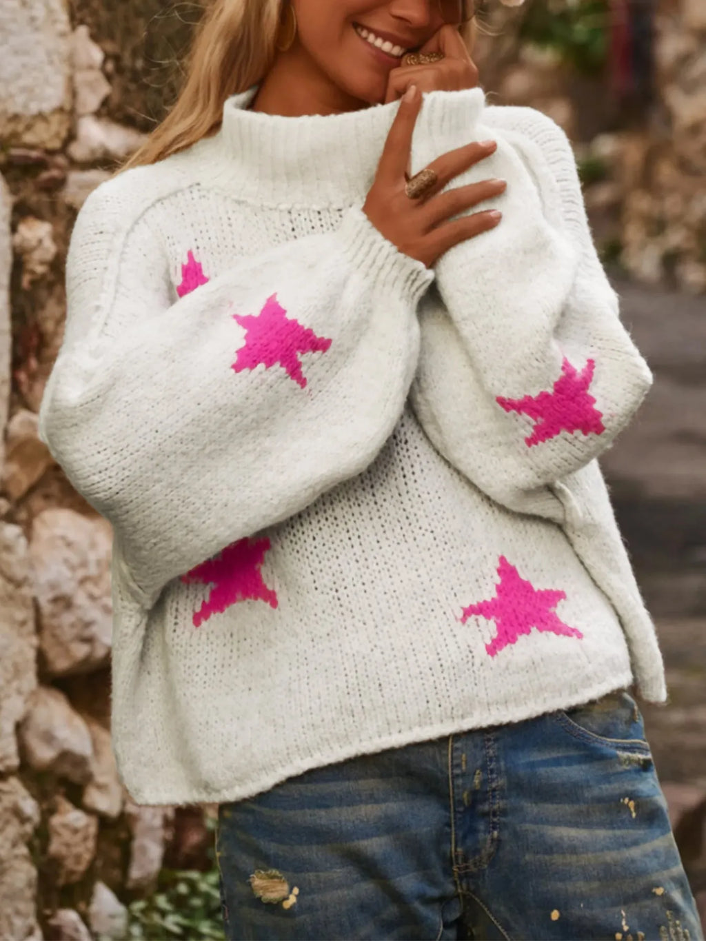 White women's loose turtleneck pullover with a thick imitation velvet texture and a five-pointed star pattern on the front.