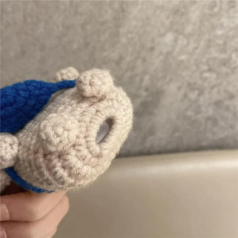 Handmade knitted koala bear backpack design cover on an AirPods case.