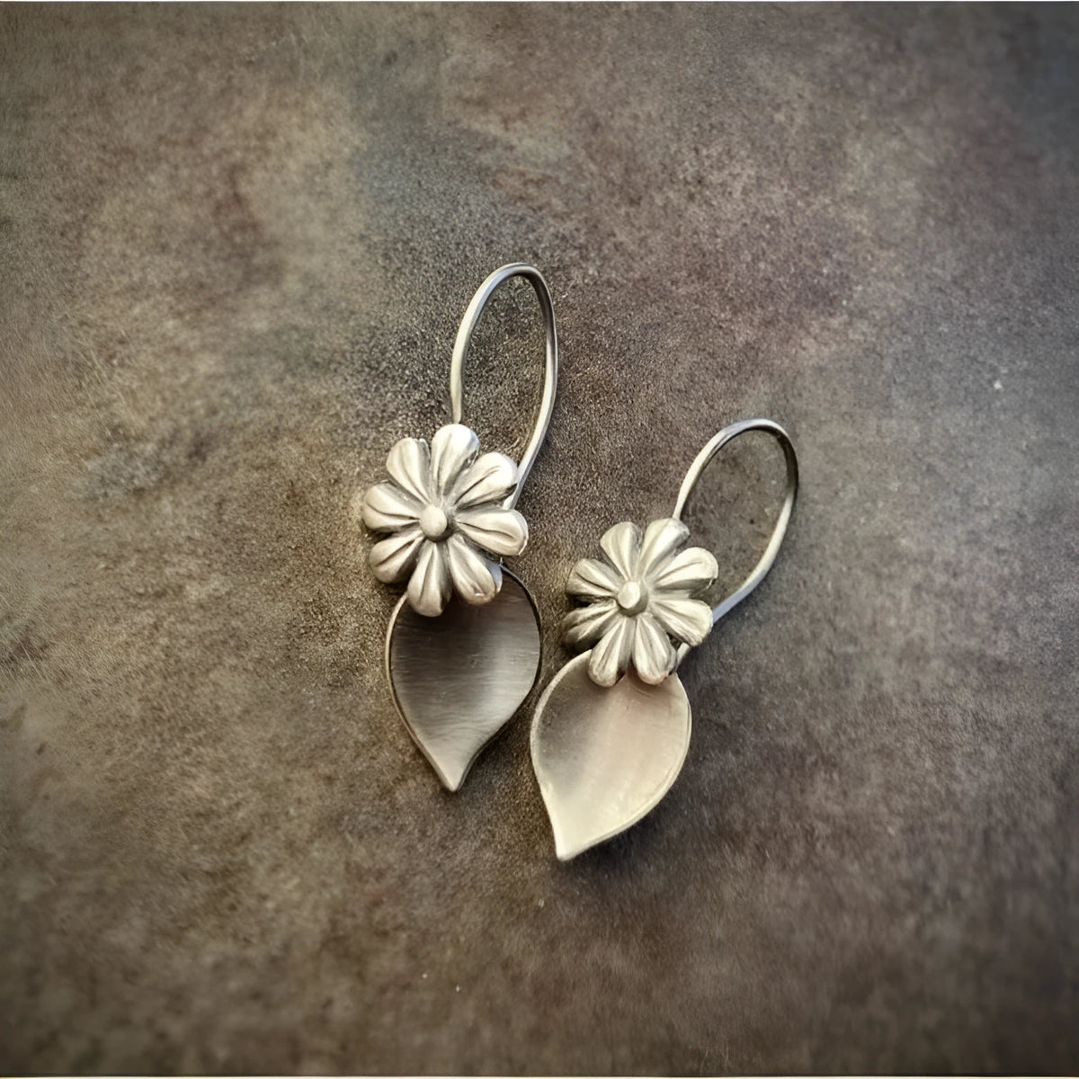 Silver alloy clip-on earrings with artificial gemstone inlays, vintage floral style, sold as a pair
