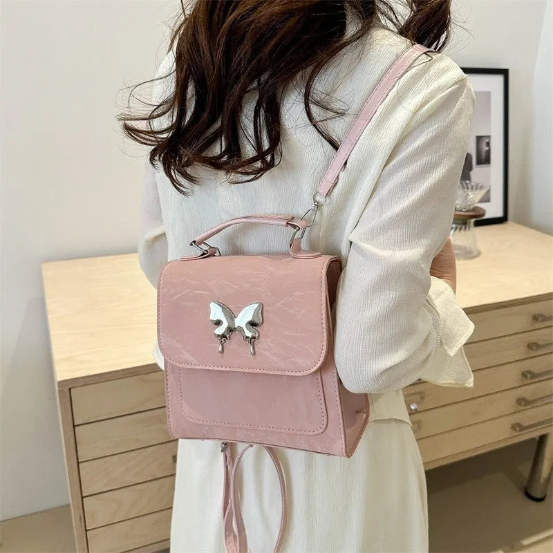Women's white PU leather hand-carry backpack with bow detail and mobile phone compartment