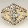 Geometric gold-coloured copper palace style ring on a plain background.