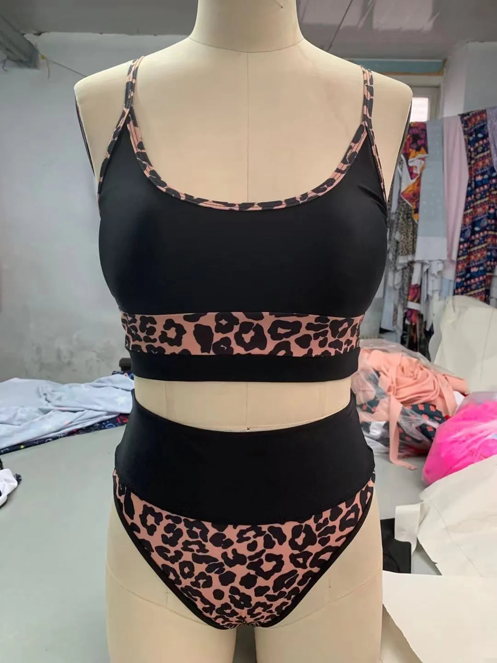 Women's high waist leopard print bikini swimsuit top and shorts set on a mannequin.