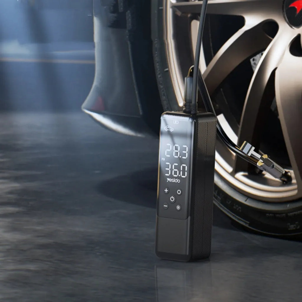 Portable 12V car tyre inflator pump in black with LED light and pressure gauge, model VC05.