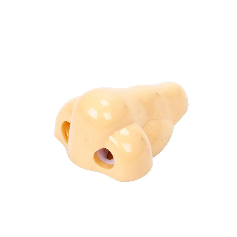 Flesh colour plastic big nostril manual pencil sharpener with geometric shape.