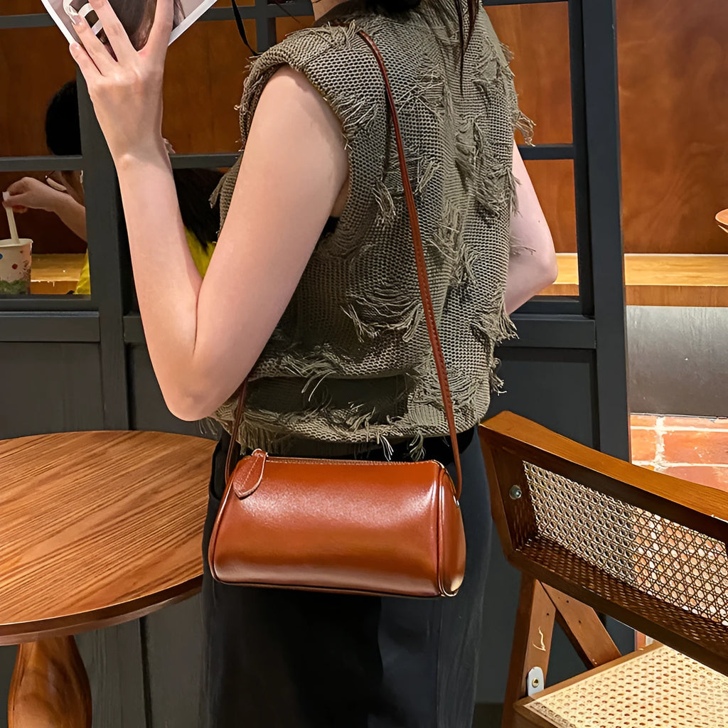 Genuine first layer cowhide crossbody bag in cylinder shape with sewing line details, available in six colours