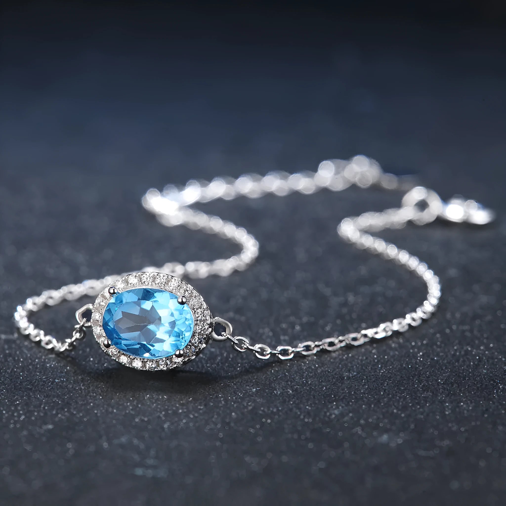 925 sterling silver blue topaz jewellery set showing necklace, ring, earrings and pendant with geometric design