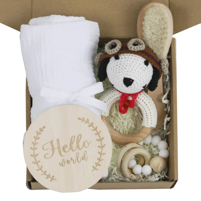Baby teething gift set with bamboo gauze blanket, wooden chewing ring, woven bell, and developmental toys