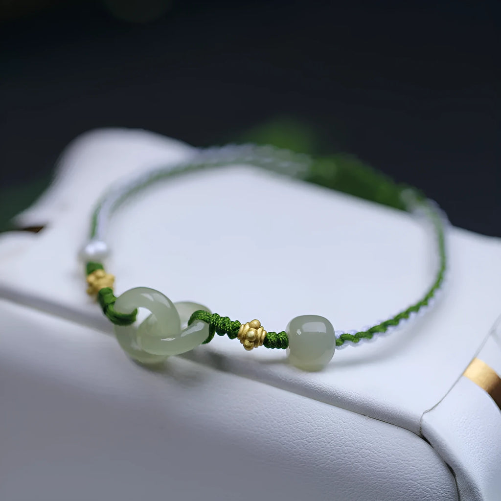 DIY woven bracelet with Hetian jade beads and silver or gold plated metal accents on a flexible wire band.