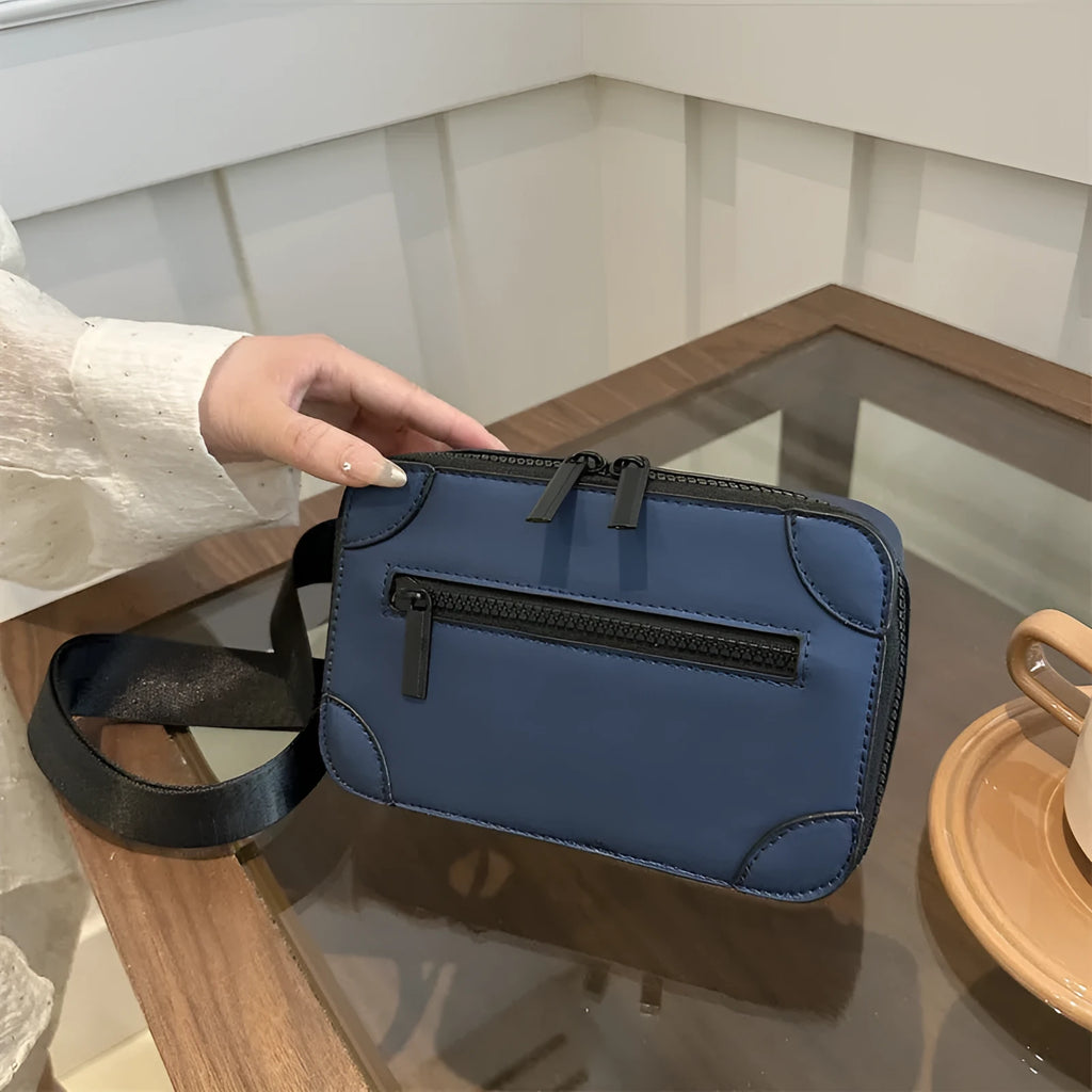 Small square black women's crossbody bag with single strap and external pockets