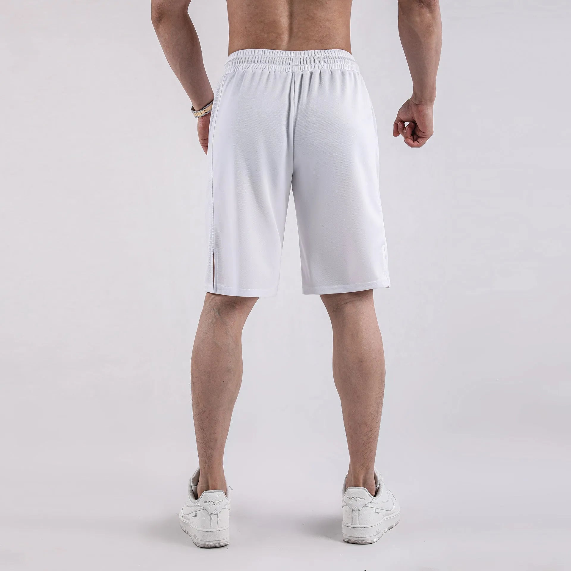 Men's black quick-dry mesh shorts with elastic waistband on a neutral background.