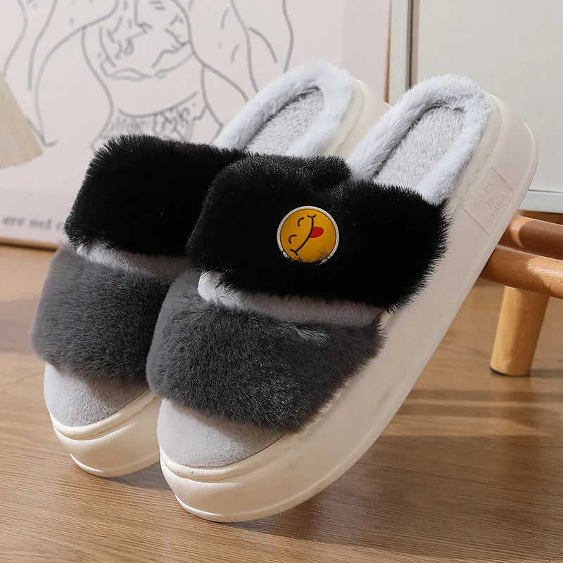 Pair of pink and green thermal cotton slippers with a plush upper and non-slip sole.
