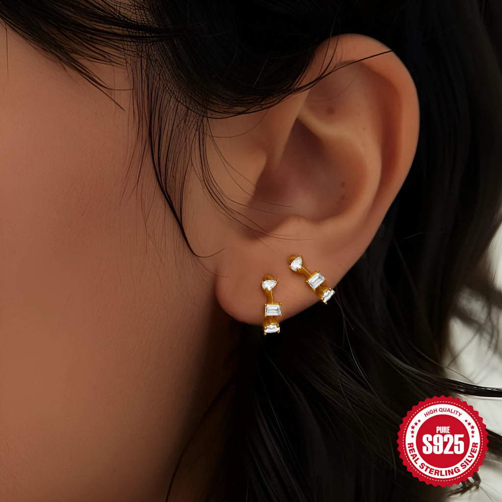 A pair of small round geometric stud earrings in sterling silver with an electroplated finish.