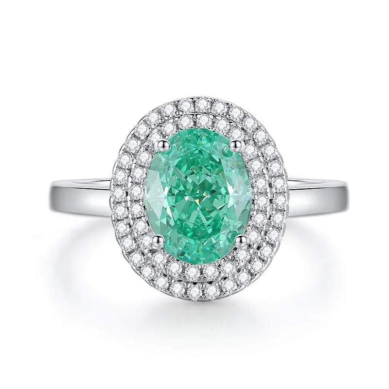 Geometric S925 silver women's ring with an emerald and inlaid high carbon diamond on a model's hand.