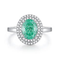 Geometric S925 silver women's ring with an emerald and inlaid high carbon diamond on a model's hand.