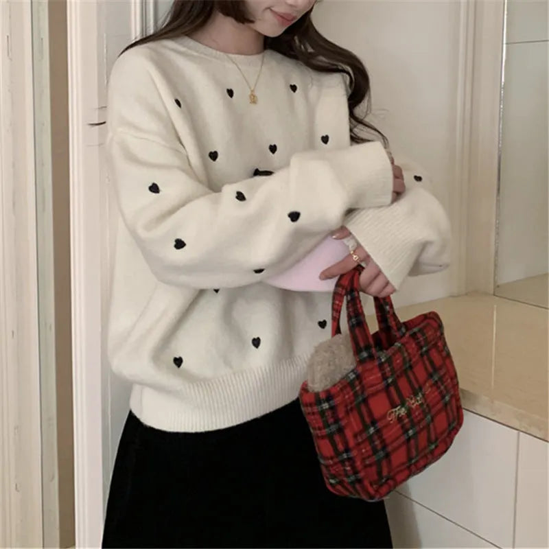 Women's loose cream pullover sweater with embroidered red love pattern on the front.
