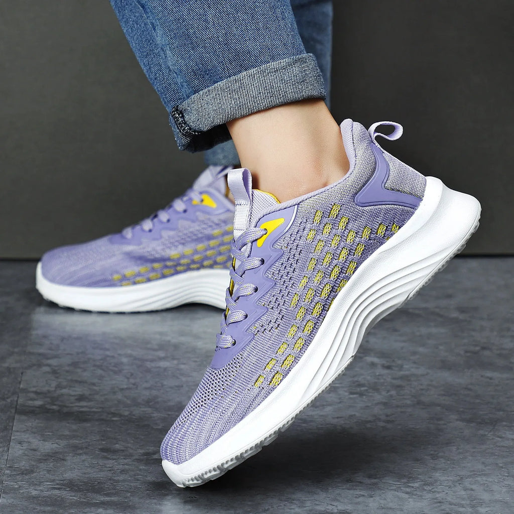 Women's Lavender Purple Flyknit running shoes with mesh detailing and a striped pattern on a white background.