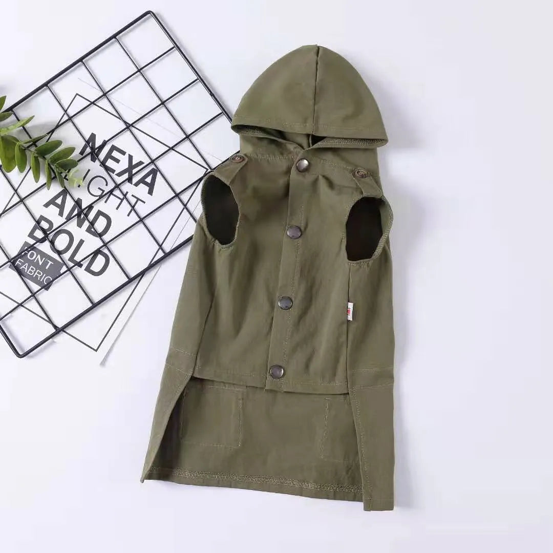 Small dog wearing a pure cotton hooded sweater in khaki with a snowflake pattern, standing on grass