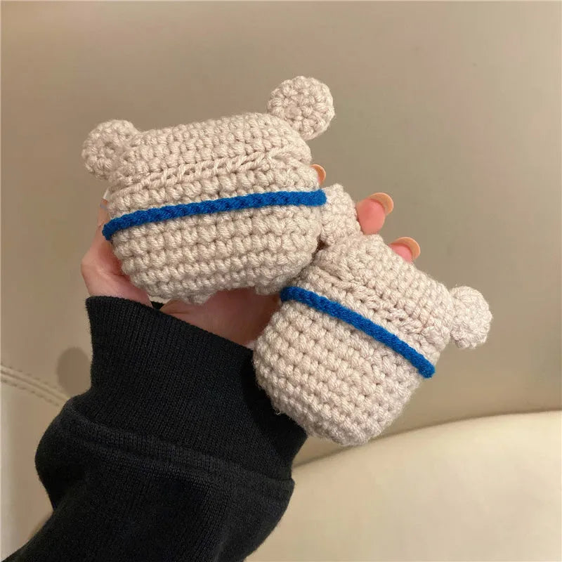 Handmade knitted koala bear backpack design cover on an AirPods case.