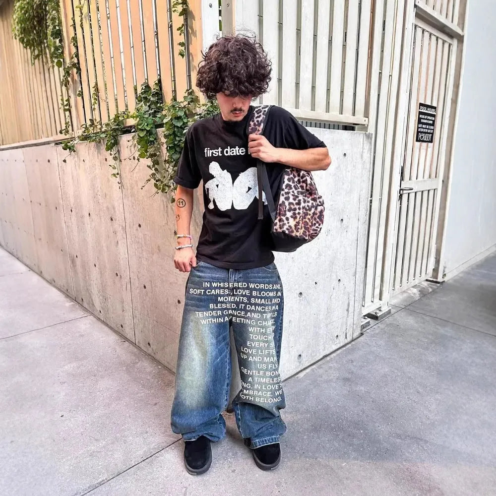 Men's black and blue cotton wide-leg straight casual trousers on a hanger, showing loose fit