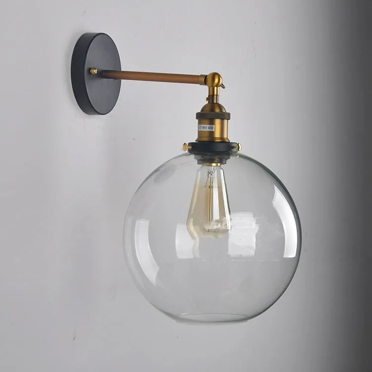 Retro-style 20cm round ball glass wall lamp with aluminium holder in amber, smoke grey, or transparent.