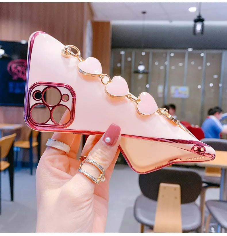 Solid colour silicone phone case with an integrated white protective bracelet on a table.