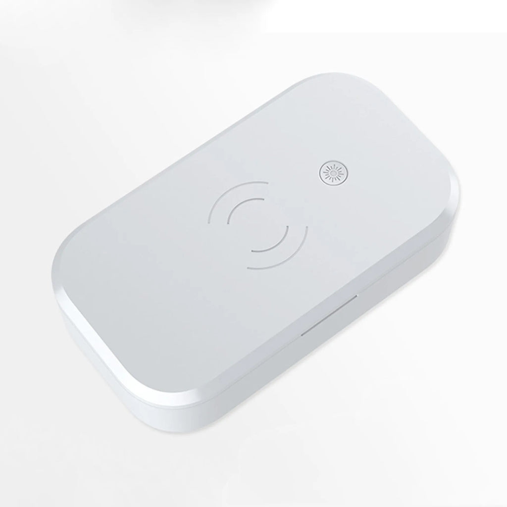 White ultraviolet disinfection box with wireless phone charging pad for nail and beauty tools.
